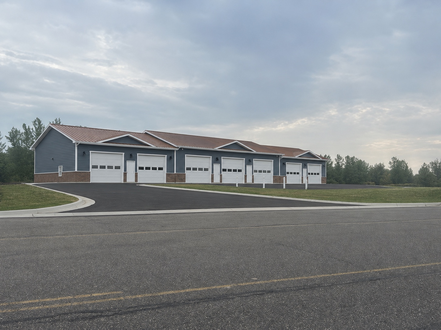 Completed Big Lake Car Condos building showing the blue-gray, white, brick and reddish-brown exterior color palette
